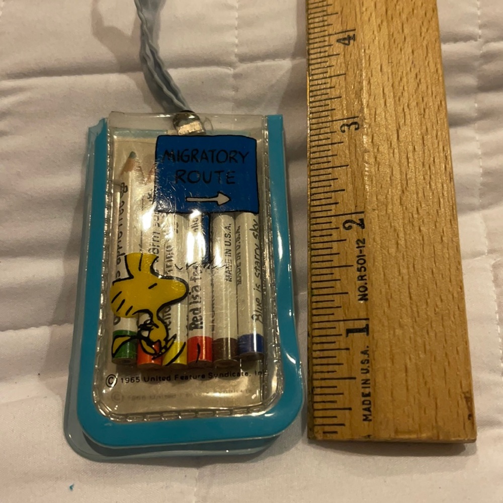 Mini Snoopy pencil and pad set on a string.